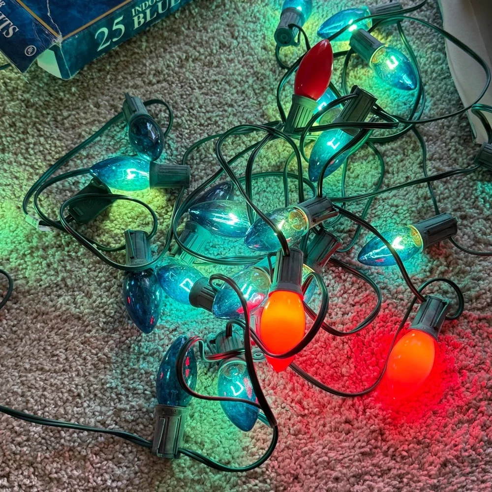 25 Indoor/Outdoor Blue String Lights Set of 2 boxes. One string has 4 red bulbs.